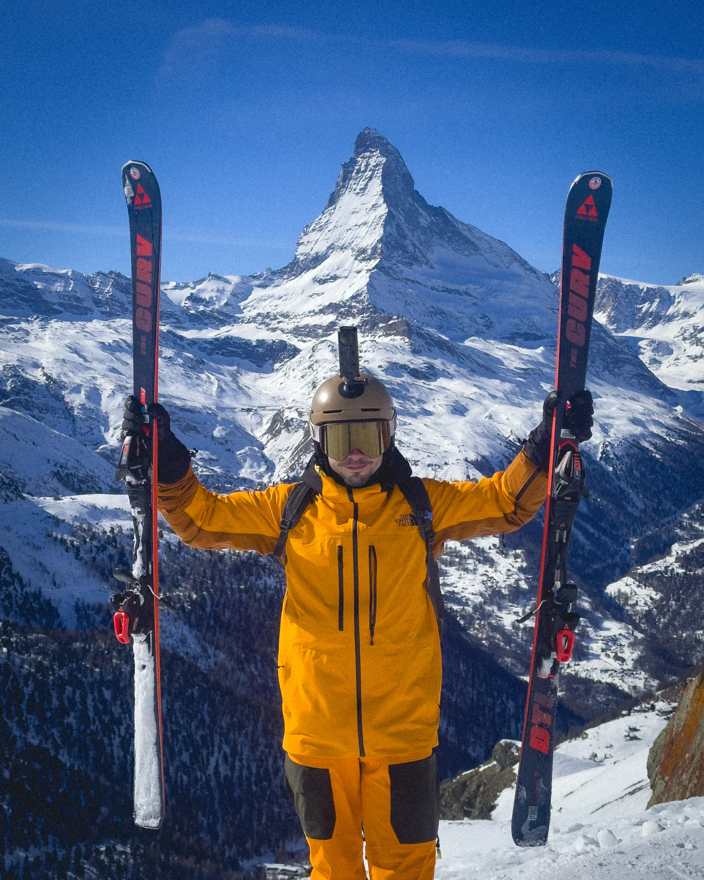 Javi holding his skis in front of the Matterhorn