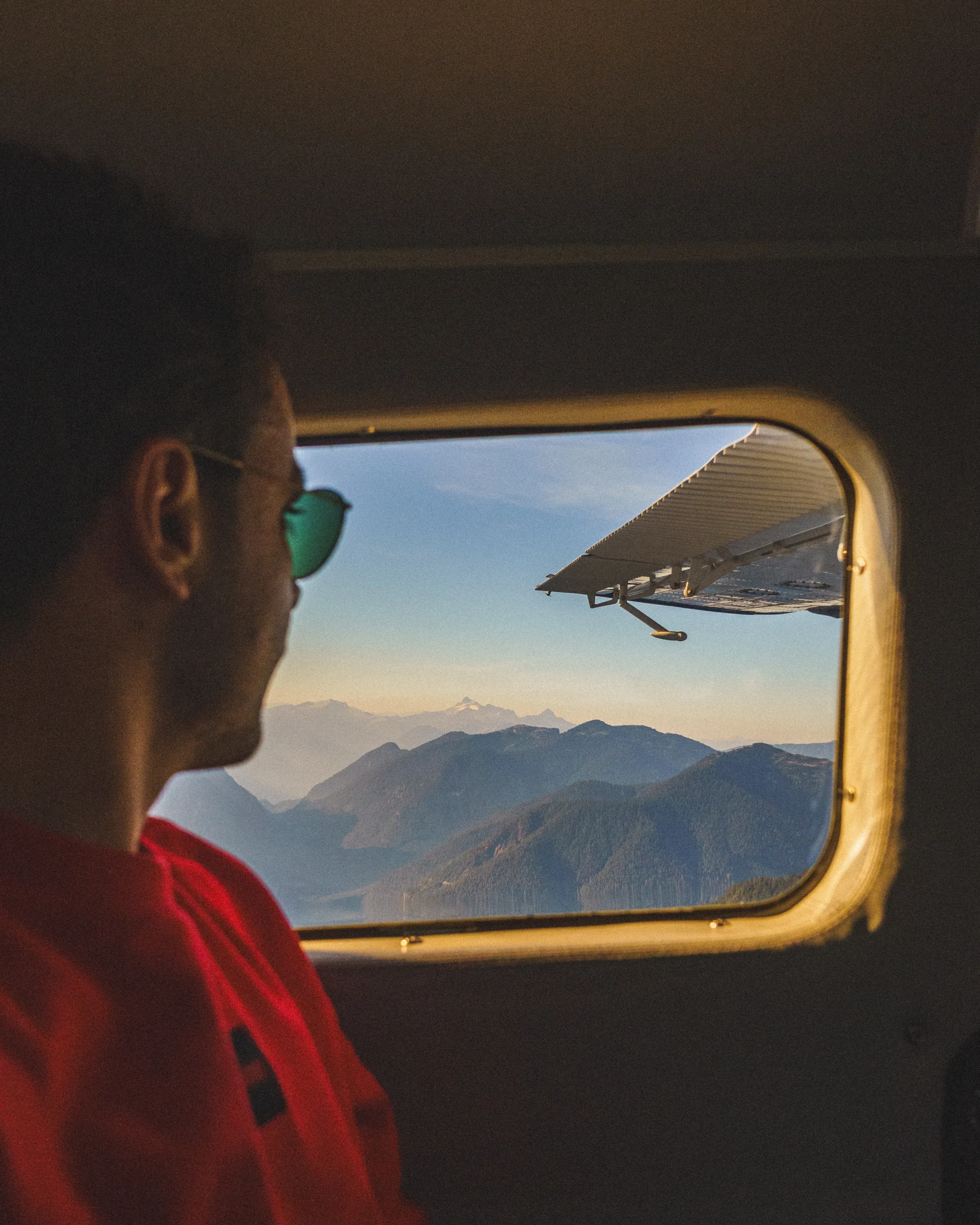 Javi looking at the mountains near Vancouver through an aeroplane window