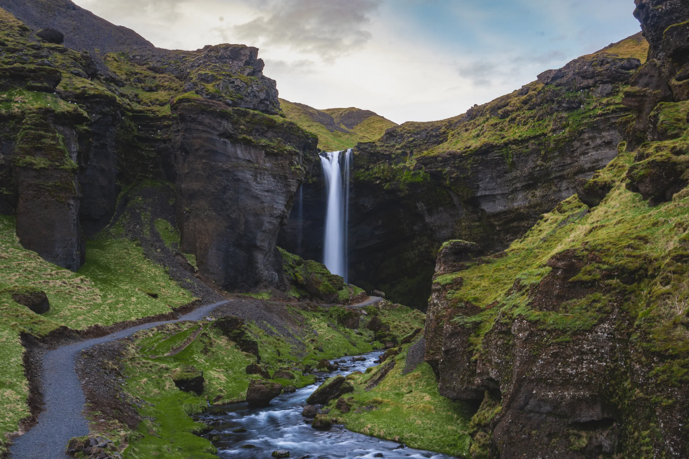 Kvernufoss waterfall dropping into a green canyon in Iceland